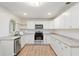 Bright kitchen with white cabinetry, stainless steel appliances, and wood-look flooring at 18341 Nw 142Nd Court Rd, Williston, FL 32696