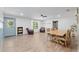 Large living room boasts wood flooring, with plenty of room for seating and dining at 18341 Nw 142Nd Court Rd, Williston, FL 32696