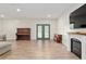 Spacious living room featuring a fireplace, wood floors, and ample natural light at 18341 Nw 142Nd Court Rd, Williston, FL 32696