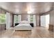 Spacious bedroom with two large windows, wood floors, and a neutral color palette at 18341 Nw 142Nd Court Rd, Williston, FL 32696