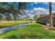 Scenic backyard with serene water feature view, enhancing the property's natural beauty at 1882 Royal Lytham Ct, Port Orange, FL 32128