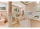 Well-lit bathroom with tile flooring, decorative wallpaper, and a shower tub with glass doors at 1882 Royal Lytham Ct, Port Orange, FL 32128
