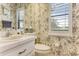 Cozy half-bathroom featuring designer wallpaper, providing style and function for guests at 1882 Royal Lytham Ct, Port Orange, FL 32128