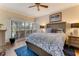 Comfortable bedroom featuring a ceiling fan, slider to the outside, and a wooden floor at 1882 Royal Lytham Ct, Port Orange, FL 32128