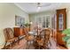Elegant dining room with decorative mirror, natural light and wood accents at 1882 Royal Lytham Ct, Port Orange, FL 32128