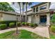 Charming home featuring beautiful landscaping, palm trees, and a welcoming front entrance with blue double doors at 1882 Royal Lytham Ct, Port Orange, FL 32128