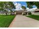 Charming home featuring a two-car garage, a well-manicured lawn, and a welcoming driveway at 1882 Royal Lytham Ct, Port Orange, FL 32128