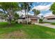 Charming home with a well-manicured lawn and mature trees, showcasing curb appeal at 1882 Royal Lytham Ct, Port Orange, FL 32128
