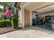 Exterior view of the garage with a large flag outside and a peek inside to storage and bikes at 1882 Royal Lytham Ct, Port Orange, FL 32128