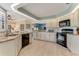 Bright kitchen featuring granite countertops, sleek appliances, and ample cabinet space for storage at 1882 Royal Lytham Ct, Port Orange, FL 32128
