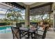 Outdoor dining area with screened-in patio, perfect for enjoying meals by the pool at 1882 Royal Lytham Ct, Port Orange, FL 32128