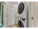 Convenient laundry room with a stacked washer and dryer unit and a utility sink at 1882 Royal Lytham Ct, Port Orange, FL 32128
