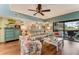 Bright living room with access to the lanai, featuring comfortable seating and modern decor at 1882 Royal Lytham Ct, Port Orange, FL 32128