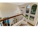 Well-lit staircase with a view of large windows, adding natural light and architectural interest at 1882 Royal Lytham Ct, Port Orange, FL 32128