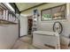 Exterior utility area with a generator, shelving in an open utility room, and a window at 1882 Royal Lytham Ct, Port Orange, FL 32128
