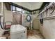 Enclosed porch with brick flooring, utility storage, and access to a utility door at 1882 Royal Lytham Ct, Port Orange, FL 32128