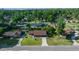 Aerial view of the property showcasing its well-manicured lawn, mature trees, and convenient location in a residential neighborhood at 2030 Se 32Nd Ln, Ocala, FL 34471