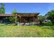 Charming backyard with a wooden pergola-covered patio and well-maintained lawn, perfect for outdoor entertaining at 2030 Se 32Nd Ln, Ocala, FL 34471