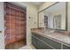 Charming bathroom with a vessel sink, marble countertop, and a well-organized closet for ample storage at 2030 Se 32Nd Ln, Ocala, FL 34471