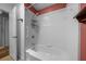 Shower/tub combo with grab bar and shelves on a tile wall with a showerhead at 2030 Se 32Nd Ln, Ocala, FL 34471