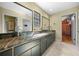Elegant bathroom featuring dual vessel sinks, marble countertops, and access to a well-organized closet at 2030 Se 32Nd Ln, Ocala, FL 34471