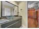 Cozy bathroom featuring a vessel sink, marble countertop, and a spacious closet for storage solutions at 2030 Se 32Nd Ln, Ocala, FL 34471