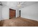 Bedroom featuring white walls and neutral carpeting, with closet and adjoining room, and ceiling fan with light at 2030 Se 32Nd Ln, Ocala, FL 34471