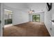 Bright bedroom featuring neutral walls, carpet flooring, and a slider door to the backyard at 2030 Se 32Nd Ln, Ocala, FL 34471