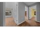Bedroom showing neutral colored walls and carpeting with an adjoining walk-in closet and open doorway to another room at 2030 Se 32Nd Ln, Ocala, FL 34471