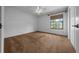 Bedroom featuring white walls and neutral carpeting, with window and ceiling fan with light at 2030 Se 32Nd Ln, Ocala, FL 34471