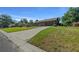 Well-maintained single-story home with a brick facade, attached garage, and a spacious front yard at 2030 Se 32Nd Ln, Ocala, FL 34471