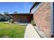 Brick home featuring a bright red front door, a concrete walkway, and manicured greenery at 2030 Se 32Nd Ln, Ocala, FL 34471