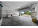 Spacious two-car garage with abundant cabinet space, storage shelves, and convenient access to the outdoors at 2030 Se 32Nd Ln, Ocala, FL 34471