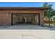 Spacious two-car garage with brick construction, storage shelves, and a convenient side entrance at 2030 Se 32Nd Ln, Ocala, FL 34471