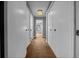 Hallway view with neutral walls and carpeting, decorative light fixture, and doors with hardware at 2030 Se 32Nd Ln, Ocala, FL 34471