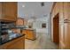 The kitchen showcases wood cabinets with granite countertops and a center island, seamlessly connected to the living room at 2030 Se 32Nd Ln, Ocala, FL 34471