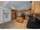 Well-equipped kitchen with wood cabinets, black granite counters, a center island, and durable tile flooring at 2030 Se 32Nd Ln, Ocala, FL 34471