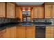 The kitchen boasts beautiful wood cabinets, granite countertops, and a modern black dishwasher at 2030 Se 32Nd Ln, Ocala, FL 34471