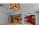 Open-concept living room flows into kitchen and red-walled sunroom, offering ample space and natural light at 2030 Se 32Nd Ln, Ocala, FL 34471