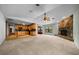 The spacious living room features an open layout, seamlessly connected to the kitchen with stone fireplace at 2030 Se 32Nd Ln, Ocala, FL 34471
