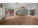 Open-concept living room with plush carpeting and access to a sunroom, enhancing natural light and living space at 2030 Se 32Nd Ln, Ocala, FL 34471