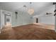 Spacious living room with vaulted ceiling, elegant chandelier, and neutral tones providing a calming atmosphere at 2030 Se 32Nd Ln, Ocala, FL 34471