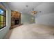 Living room features vaulted ceiling, corner stone fireplace, and lots of natural light from a large window at 2030 Se 32Nd Ln, Ocala, FL 34471
