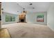 The spacious living room features a vaulted ceiling, a striking stone fireplace, and ample natural light at 2030 Se 32Nd Ln, Ocala, FL 34471
