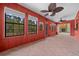 Bright sunroom featuring a decorative ceiling fan and access to a stone fireplace, perfect for relaxing at 2030 Se 32Nd Ln, Ocala, FL 34471