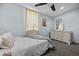 Bedroom with carpet flooring, ceiling fan, and white dresser with mirror at 21776 Nw 57Th Ave, Micanopy, FL 32667