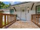 Charming front porch featuring a wooden deck, decorative accents, and a welcoming entrance to the home at 21776 Nw 57Th Ave, Micanopy, FL 32667