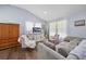 Inviting living room featuring wood floors, a vaulted ceiling, modern furniture, and lots of natural light at 21776 Nw 57Th Ave, Micanopy, FL 32667
