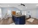 Open-concept living area seamlessly integrates the kitchen, dining, and living spaces with wood flooring and vaulted ceilings at 21776 Nw 57Th Ave, Micanopy, FL 32667
