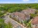 Aerial view of the townhome community surrounded by green trees, showing proximity to roads and nature at 2950 Lucayan Harbour Cir # 107, Kissimmee, FL 34746